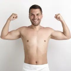 Uśmiechnięty mężczyzna prezentuje swoją szewską klatkę piersiową, napinając bicepsy.